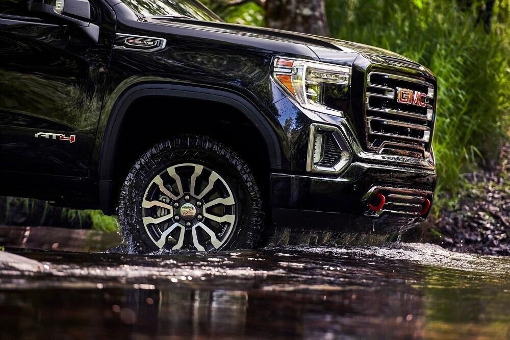 GMC Sierra 1500 purchased from McGavock GMC of Pampa driving through a stream.